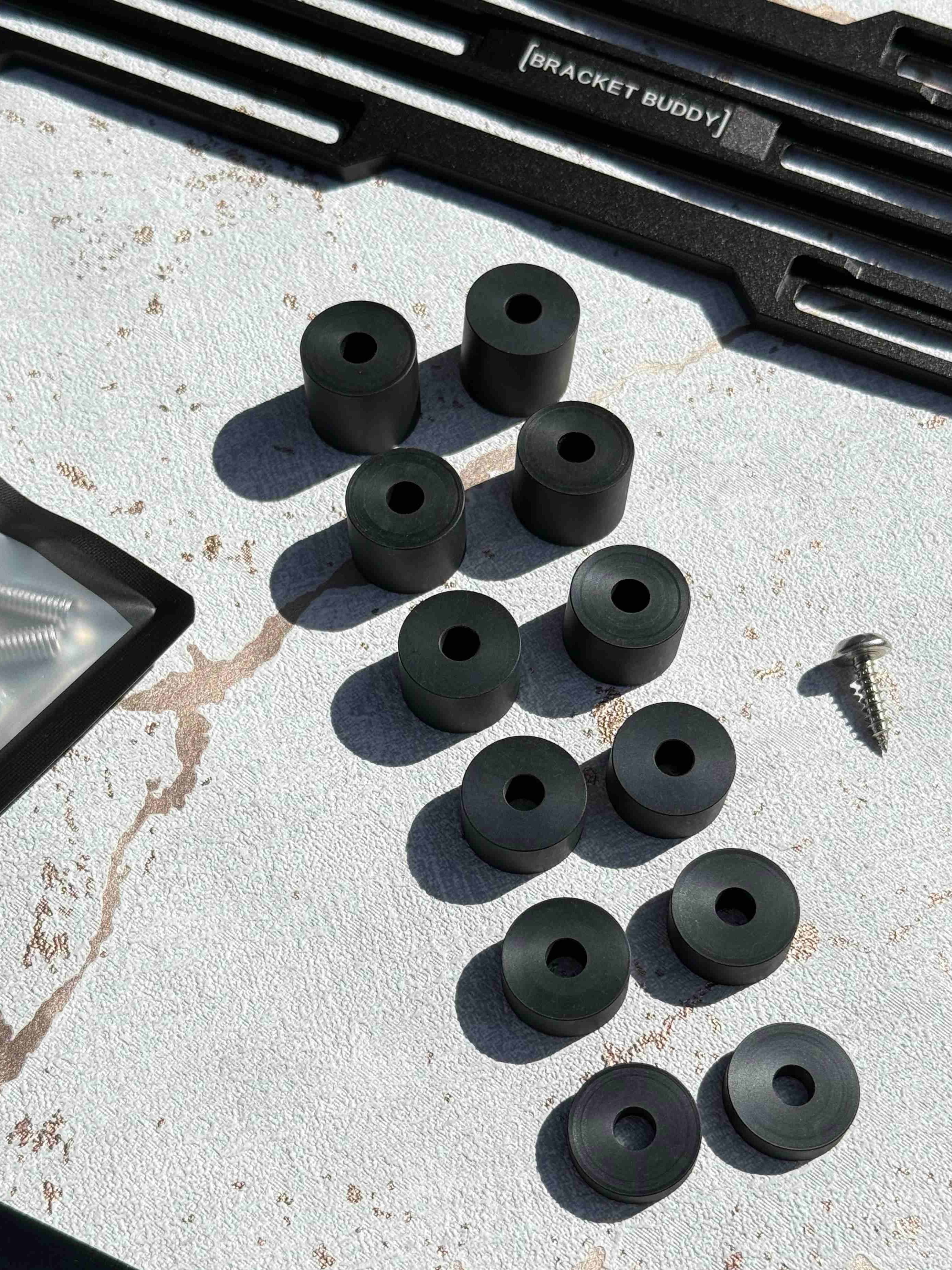Multi-size spacer kit used to level number plate brackets on uneven bumpers